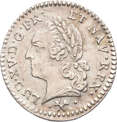 gros plan d'une pièce de monnaie sur laquelle figure une tête de femme