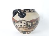 a vase that has a picture of a barn on it