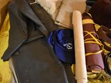 a pile of clothes and other items on a bed