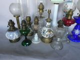 a lot of glass and brass lamps on a table