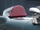 a close up of a red seat on a green car