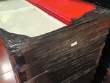 a large stack of black and red folders on a table