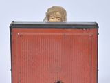 a teddy bear that is sitting on top of a red box