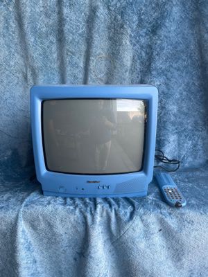 a small blue television sitting on a blue blanket