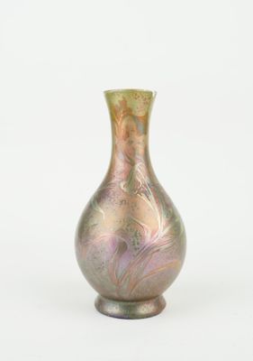 a glass vase that is sitting on a white surface