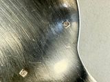 a silver spoon with a hole in the middle of it