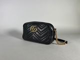 the black quilted camera bag with a gold chain strap