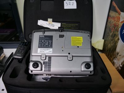 a suitcase with a laptop and a remote on top of it