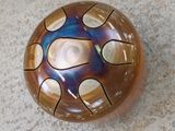 a brown and blue bowl sitting on the floor
