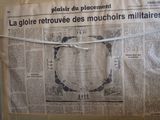 newspaper with a piece of paper taped to the front of it