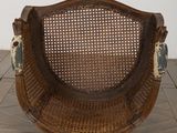 a wicker chair with a blue and white seat