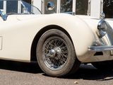 an image of a classic sports car parked in front of a building