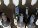 several bottles of wine are lined up in a row on a counter