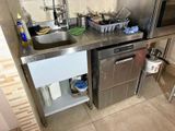 a kitchen with a sink, microwave, and a dishwasher