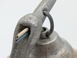 a close up of a metal object on a white surface