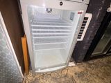 a small refrigerator with a door open on the floor