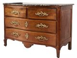 a wooden chest of drawers with a marble top