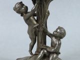 a statue of a boy and a girl on a rock