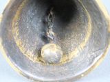 a close up of a metal object with a chain on it