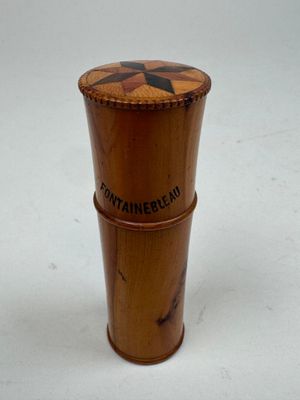 a small wooden container with a star design on it