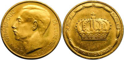 a close up of a gold coin with a crown on it