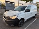 the white van is parked in a parking lot near a tree