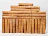 the books are stacked on top of each other on a white surface