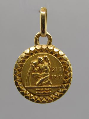 a close up of a gold medal with a woman holding a child