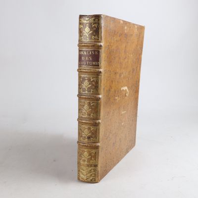 an old book sitting on top of a wooden table