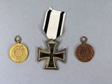 two medals and a coin are sitting on a table