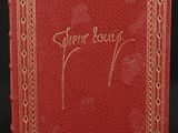 a red book with gold writing on it and a black background