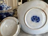a blue and white tea pot and a white and blue tea pot on a marble table
