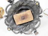 a small metal object with a wooden block in it