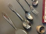 several spoons, measuring spoons, measuring cups, and measuring spoons are laid out on a table