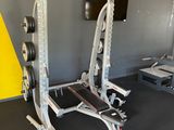 a gym room with a barbell and a weight machine