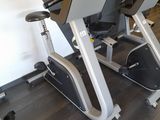two stationary exercise bikes in a gym room
