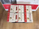 six boxes of cat food sitting on a wooden floor next to a box of cat food