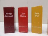 four different types of perfumes are lined up on a table