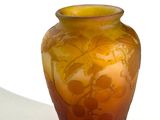 a vase that has a yellow and brown design on it