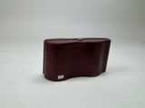 a brown leather case sitting on a white surface