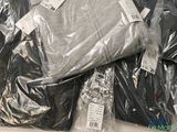 a pile of clothing wrapped in plastic on a table