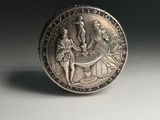a close up of a coin on a white surface with a black background