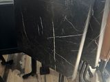 a cat that is sitting under a table