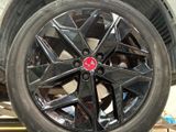 a close up of a tire on a car in a garage