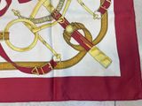 a red and white scarf with a gold design on it