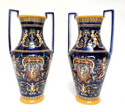 pair of blue and gold vases sitting on a white surface