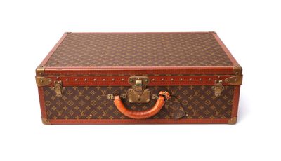 a brown and red suitcase sitting on a white surface