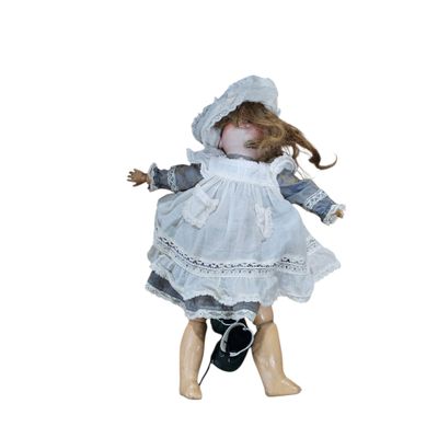 a doll that is wearing a white dress and a hat