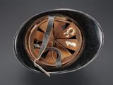 an overhead view of a helmet with a broken visor on a gray background