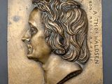 a close up of a plaque with a woman ' s face on it